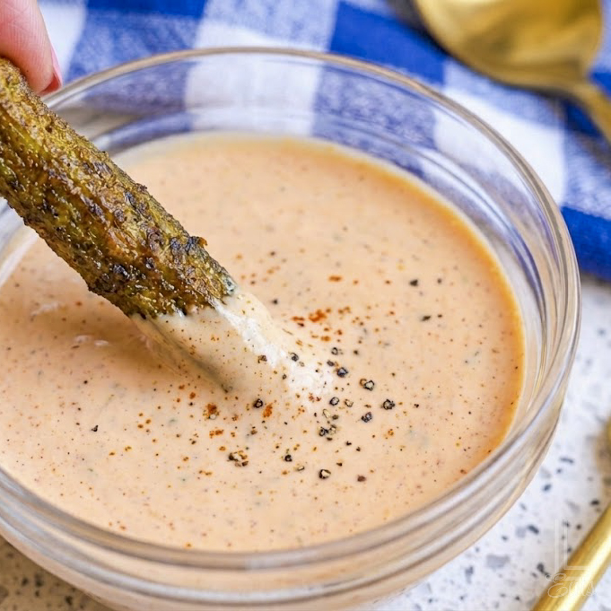 dipping the golden brown, crispy okra pod in a pink mayonnaise-based dipping sauce.