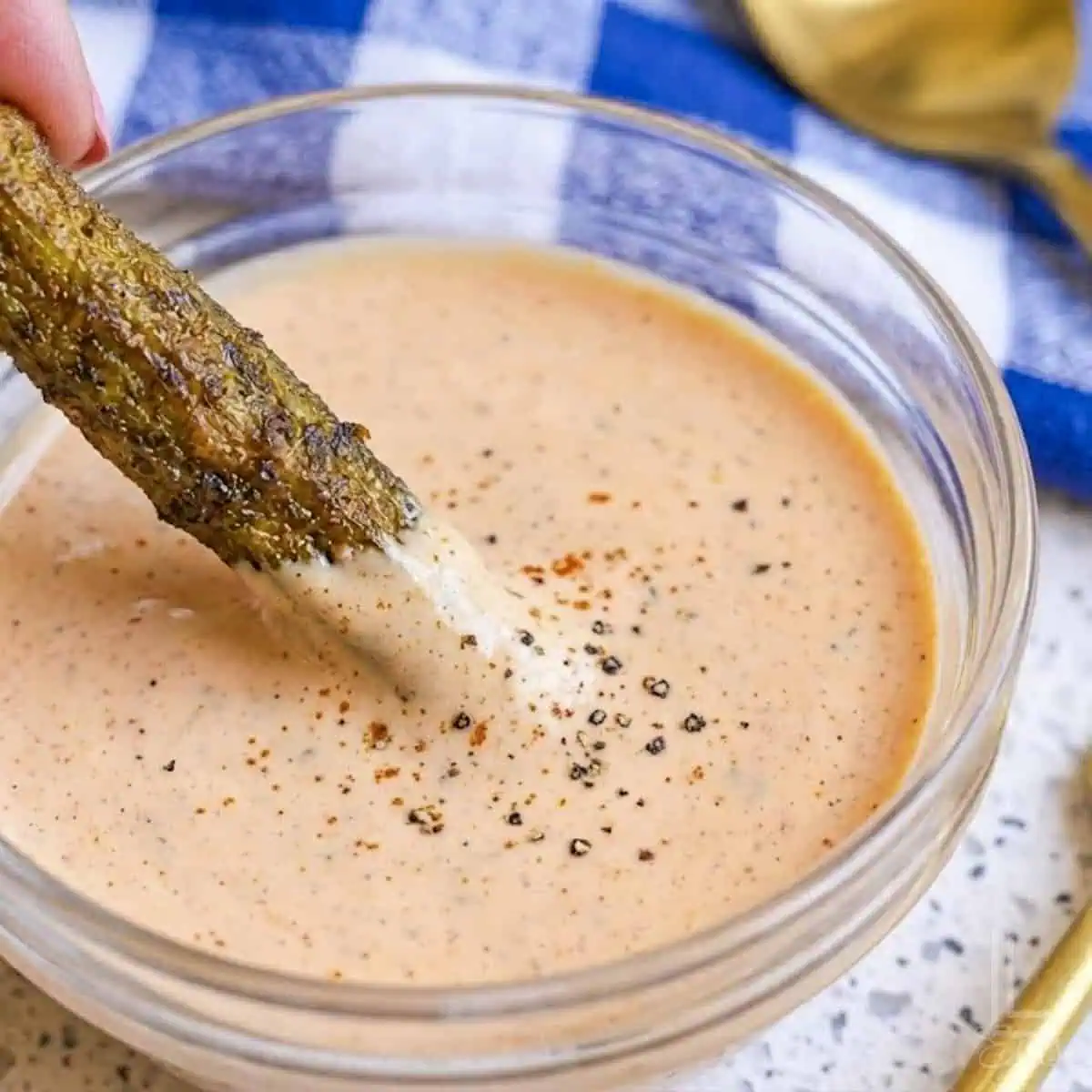 dipping the golden brown, crispy okra pod in a pink mayonnaise-based dipping sauce.