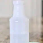 DIY granite cleaner spray bottle with cloth for countertops.