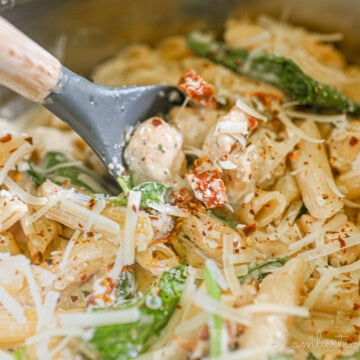 scooping a spoon of marry me chicken pasta.