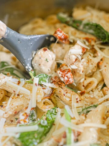 scooping a spoon of marry me chicken pasta.