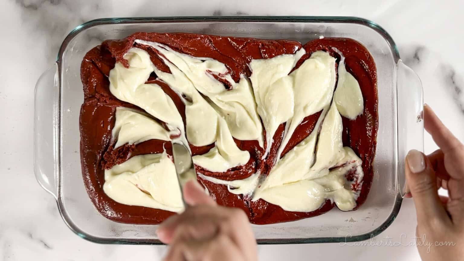 swirling cream cheese mixture into the red velvet brownie batter.