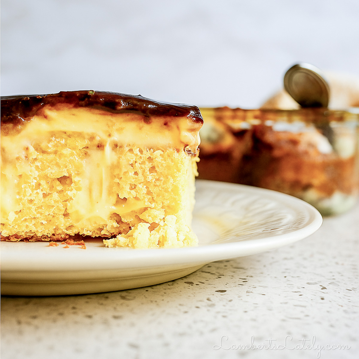 looking at the side of a piece of boston creme poke cake.