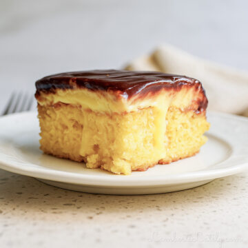 piece of boston cream poke cake on a plate.