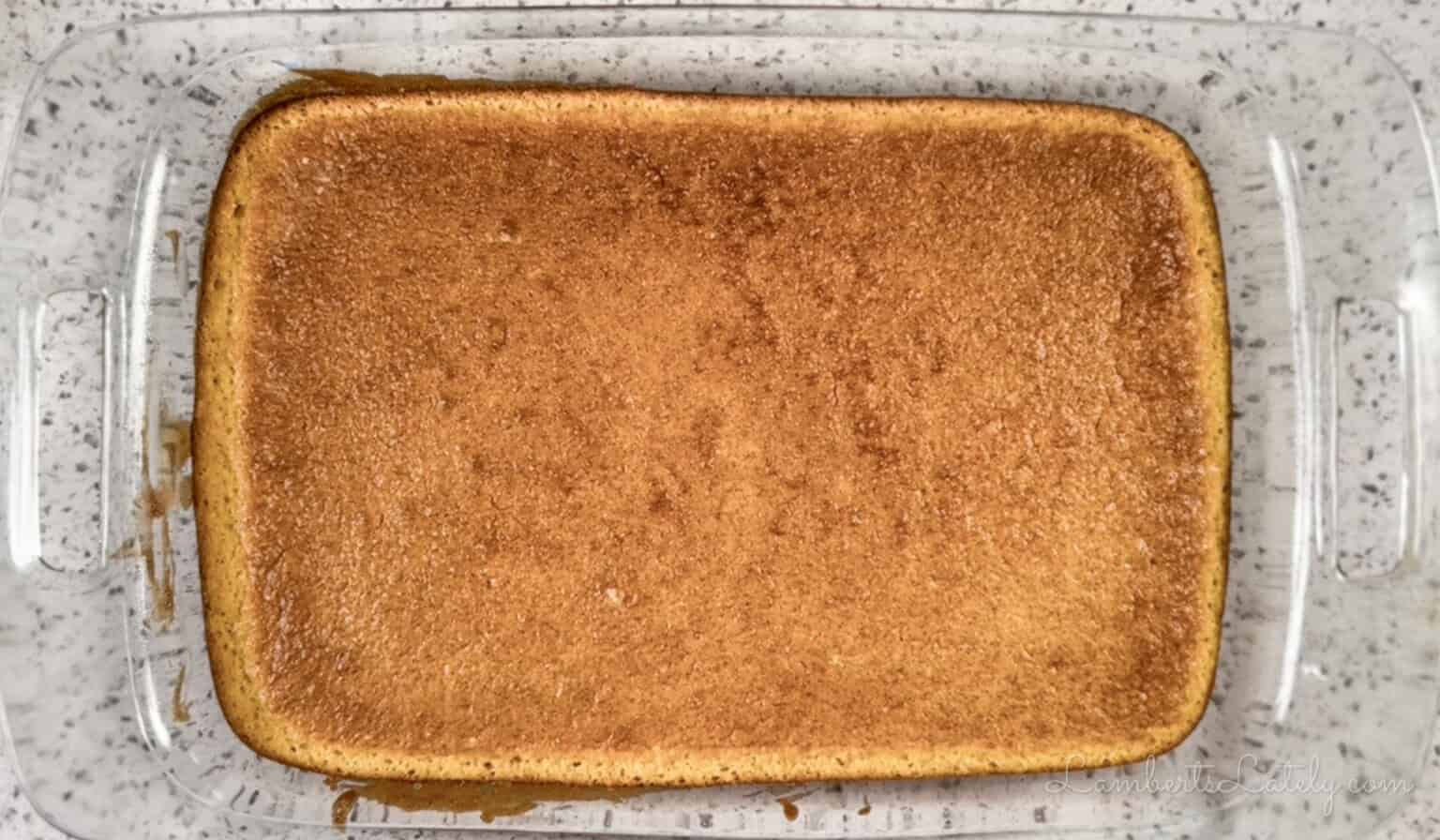 baked yellow sheet cake in a glass dish.