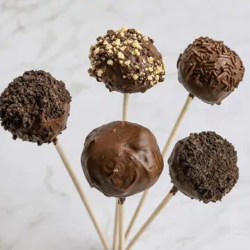 a set of 5 brownie cake pops with various chocolate coatings and decorations.