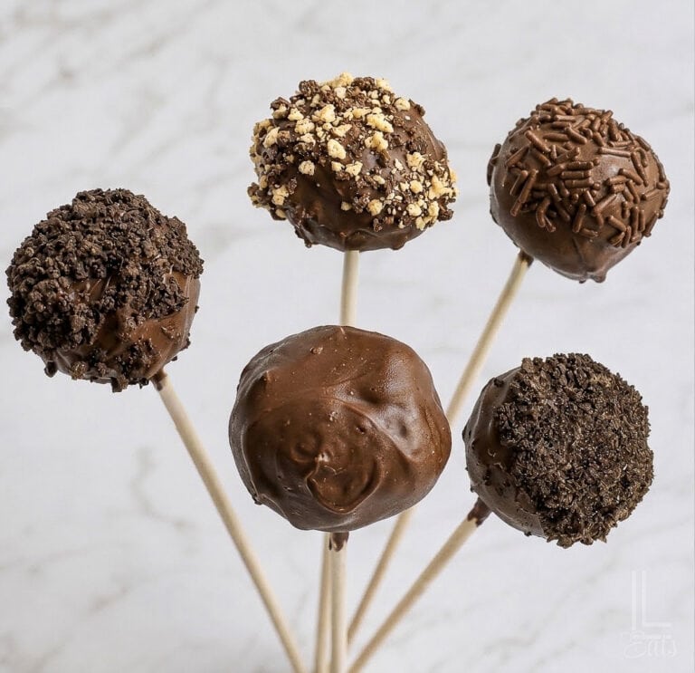 a set of 5 brownie cake pops with various chocolate coatings and decorations.