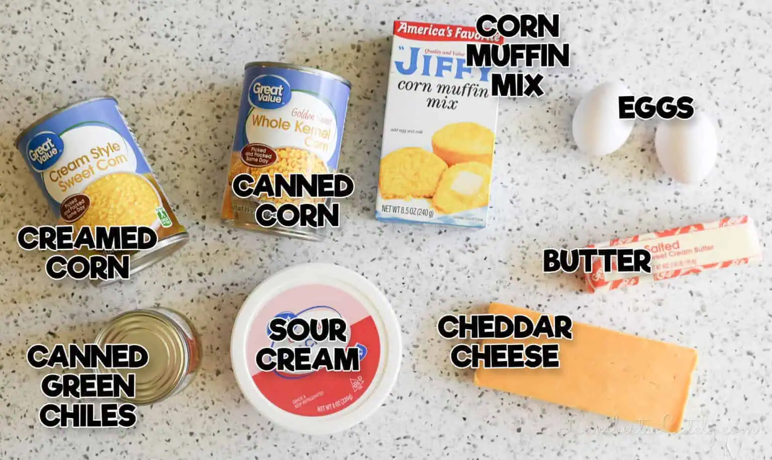 Crock Pot corn casserole ingredients with Jiffy mix, cheddar, eggs, and green chiles.