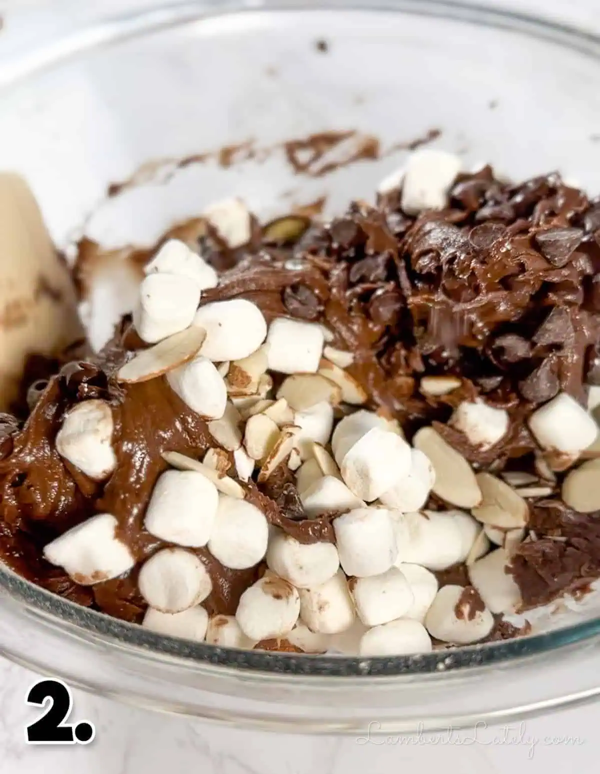 folding in marshmallows, chocolate chips, and almonds into brownie mix.
