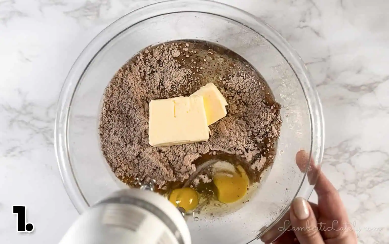 mixing butter, eggs, and brownie mix in a bowl.