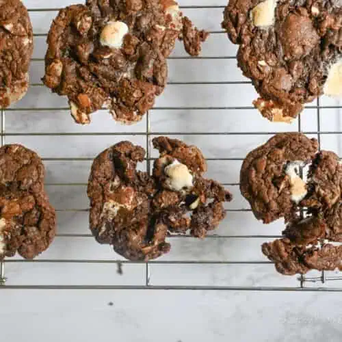 rocky road cookies on a baking rack.