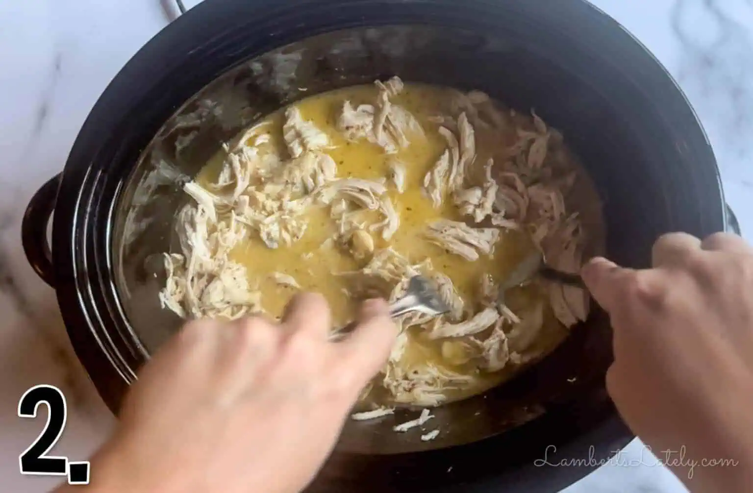 using forks to shred chicken in the crock pot.