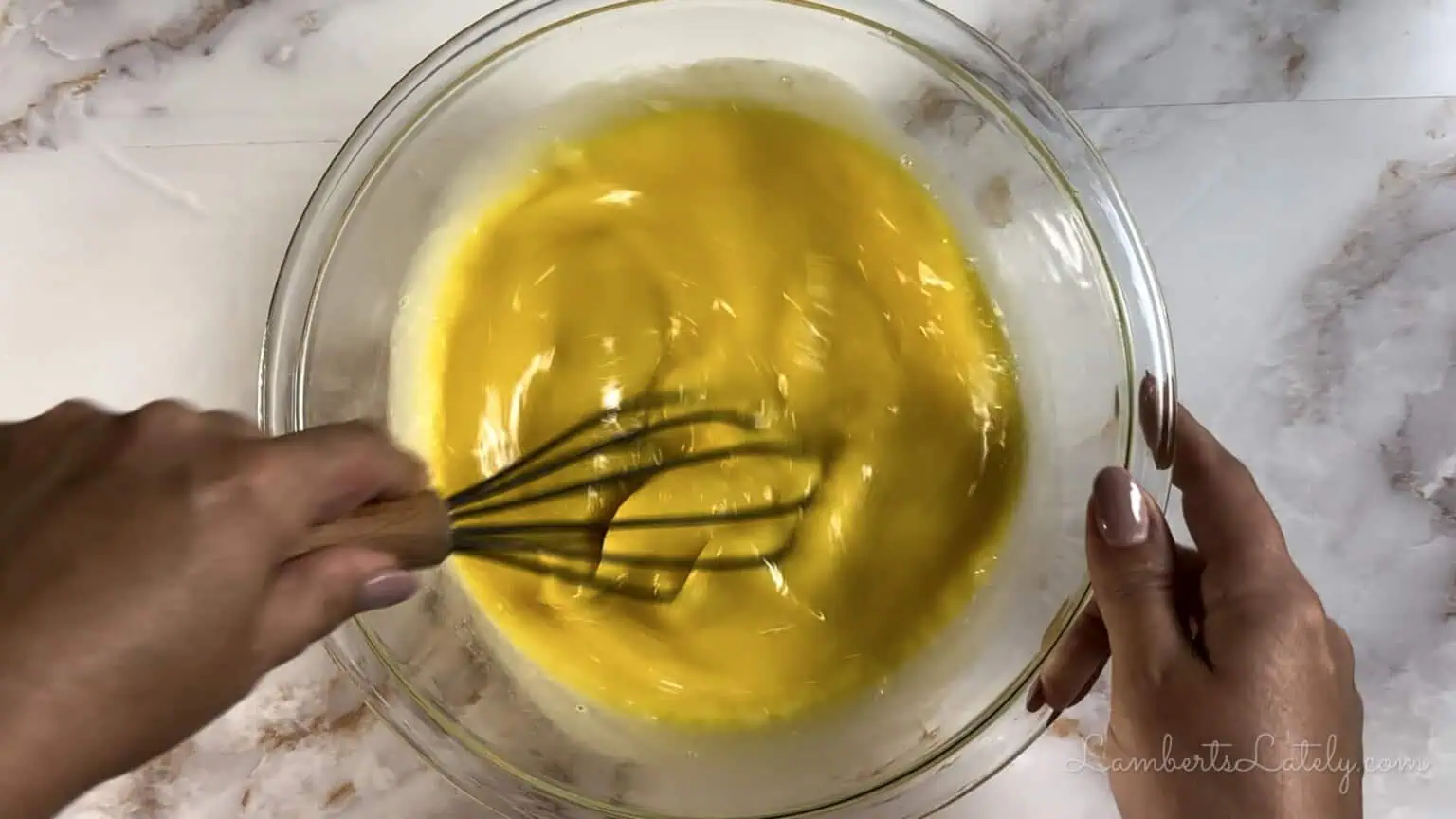 stirring custard in a bowl.