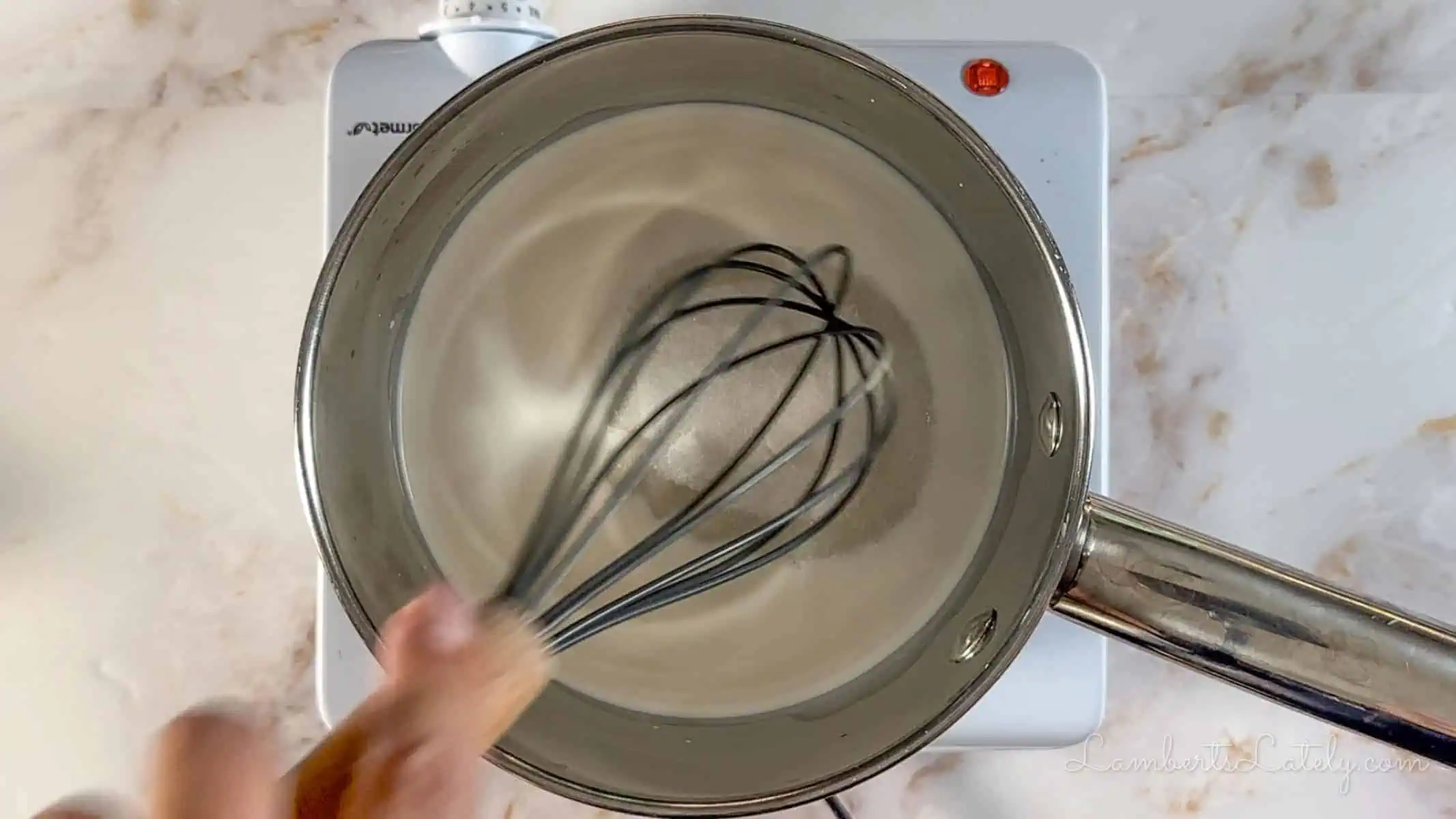 stirring milk and sugar in a sauce pan.