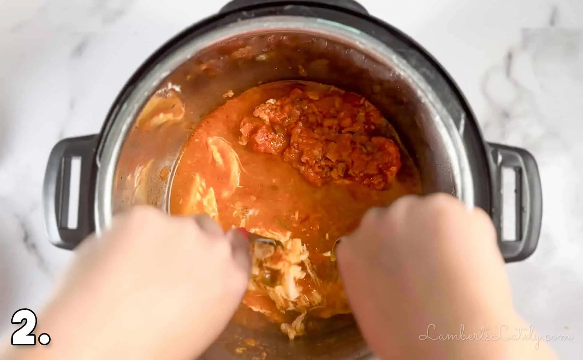 shredding cooked chicken in salsa in an instant pot.