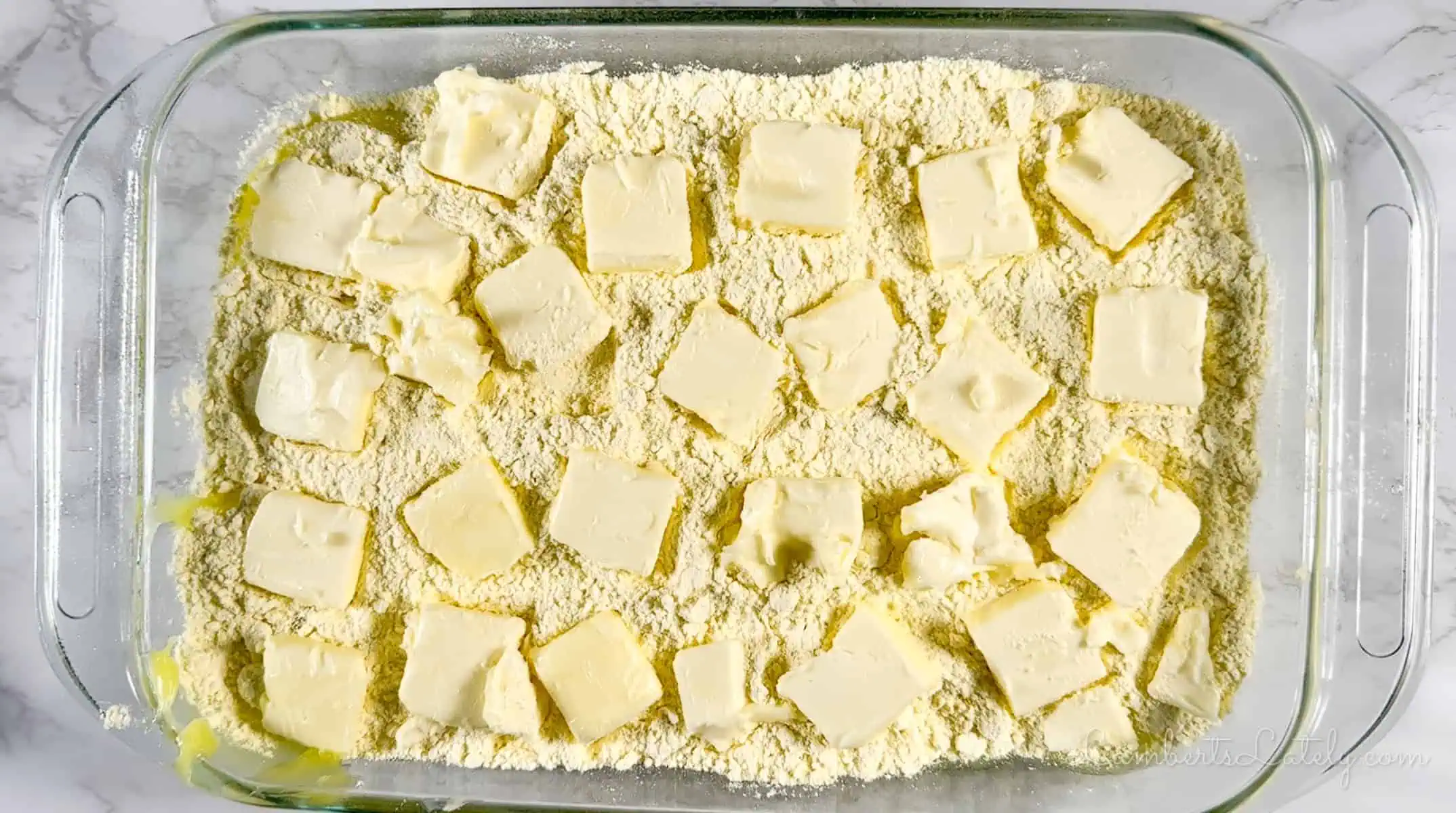 butter slices added over the cake mix in a baking dish.