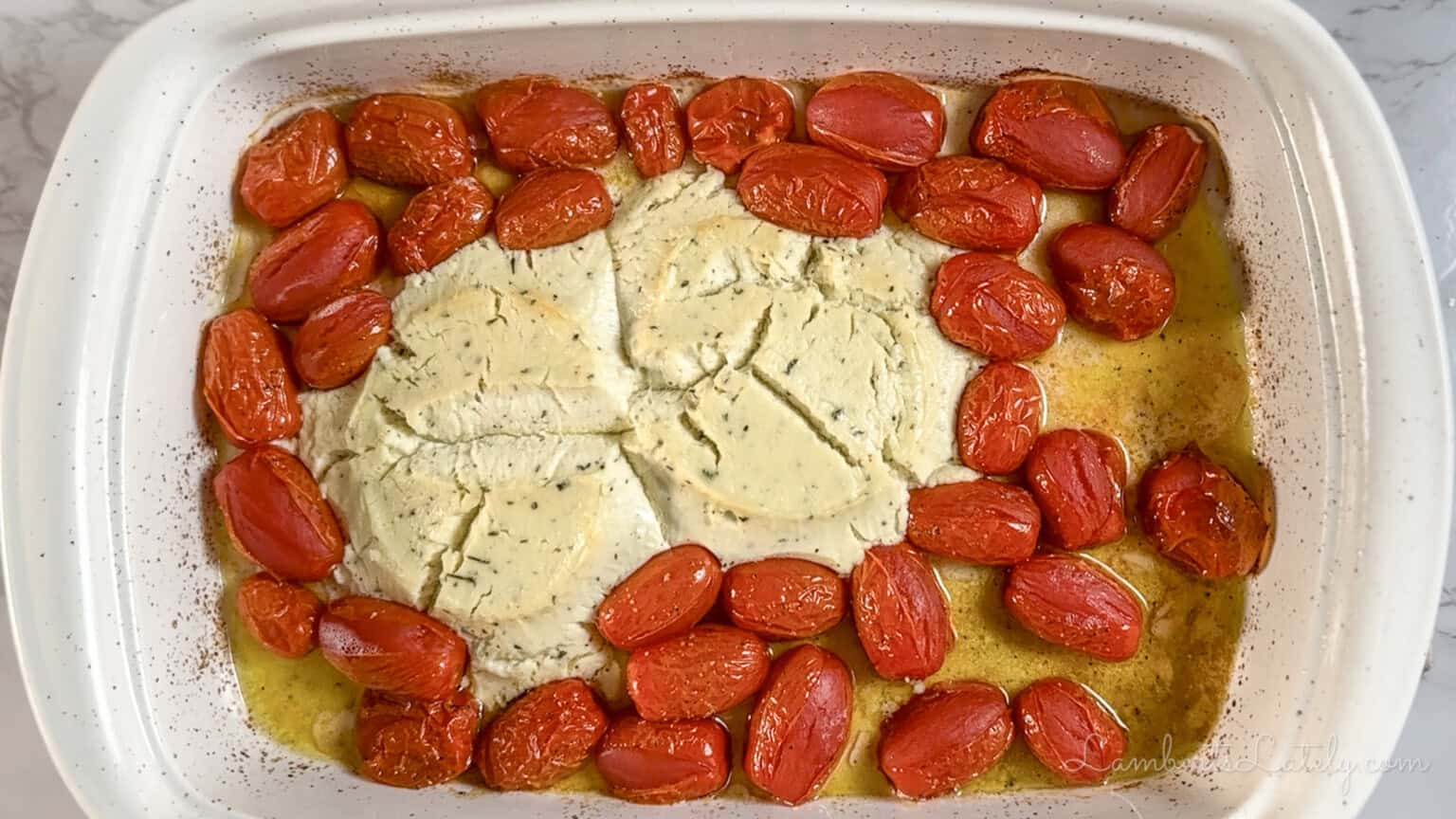 cheese and tomatoes in a casserole dish after baking.