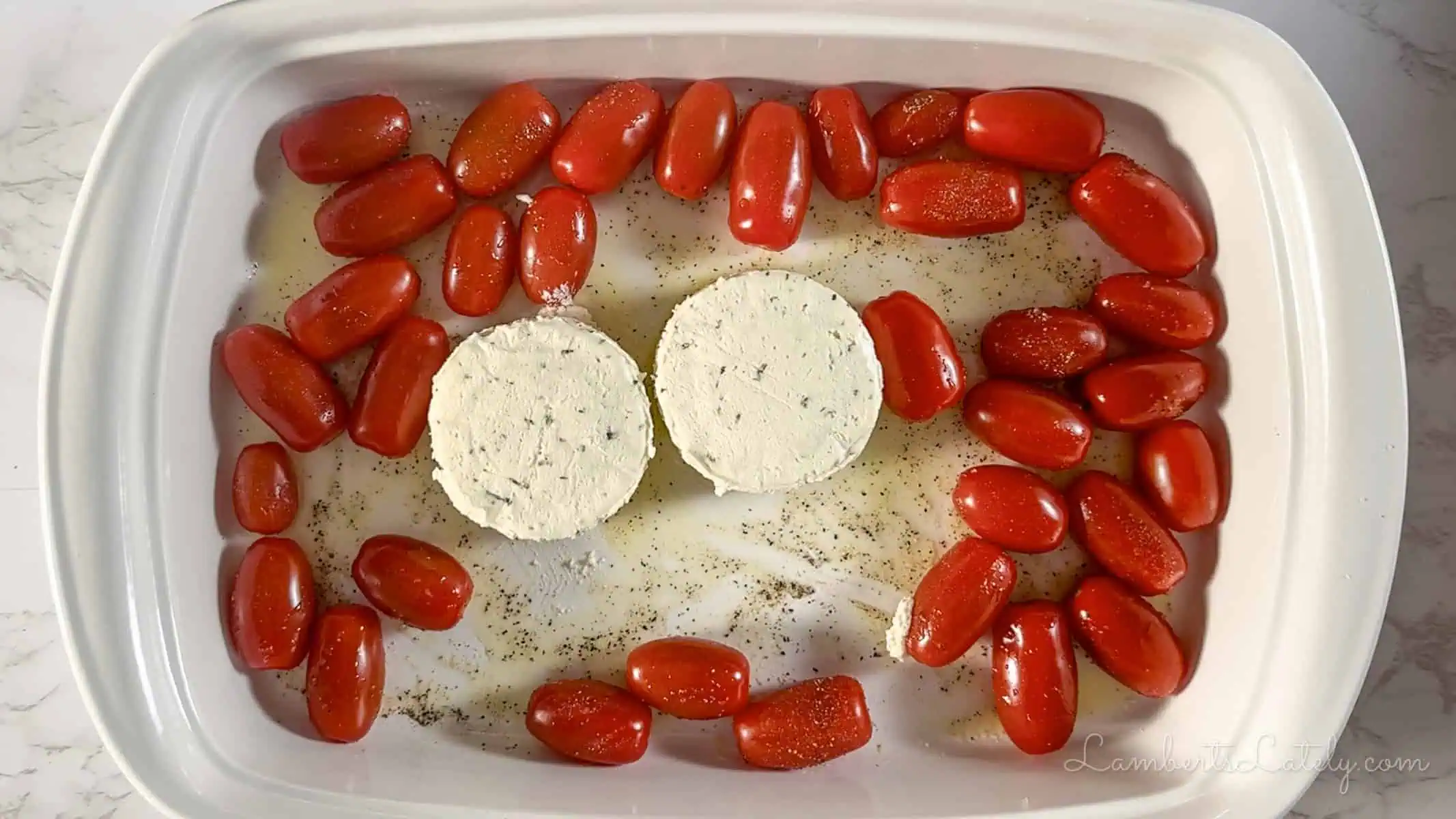 boursin cheese and grape tomatoes in a casserole dish.