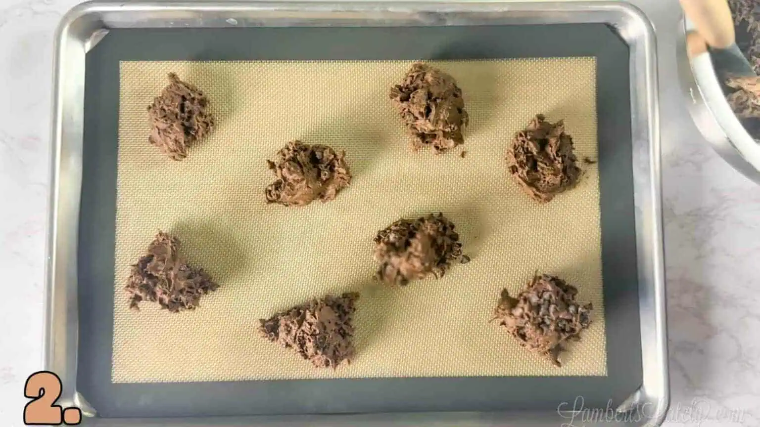 brownie mix cookie dough scooped onto a baking sheet in small portions.