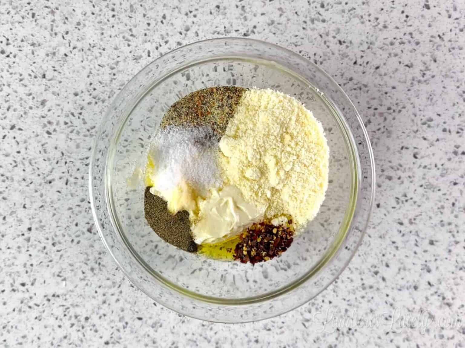 ingredients for a creamy sub sandwich dressing in a glass bowl.