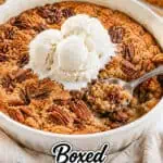 Delicious pecan cobbler with ice cream in a baking dish, ready to serve.