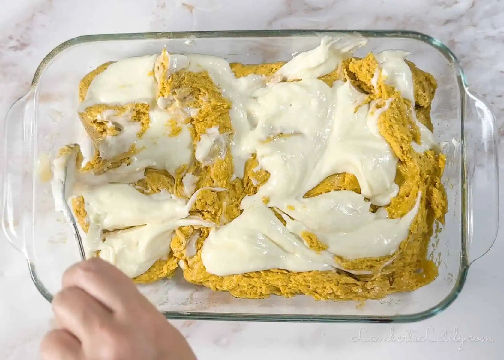 swirling cream cheese into unbaked pumpkin bar batter.