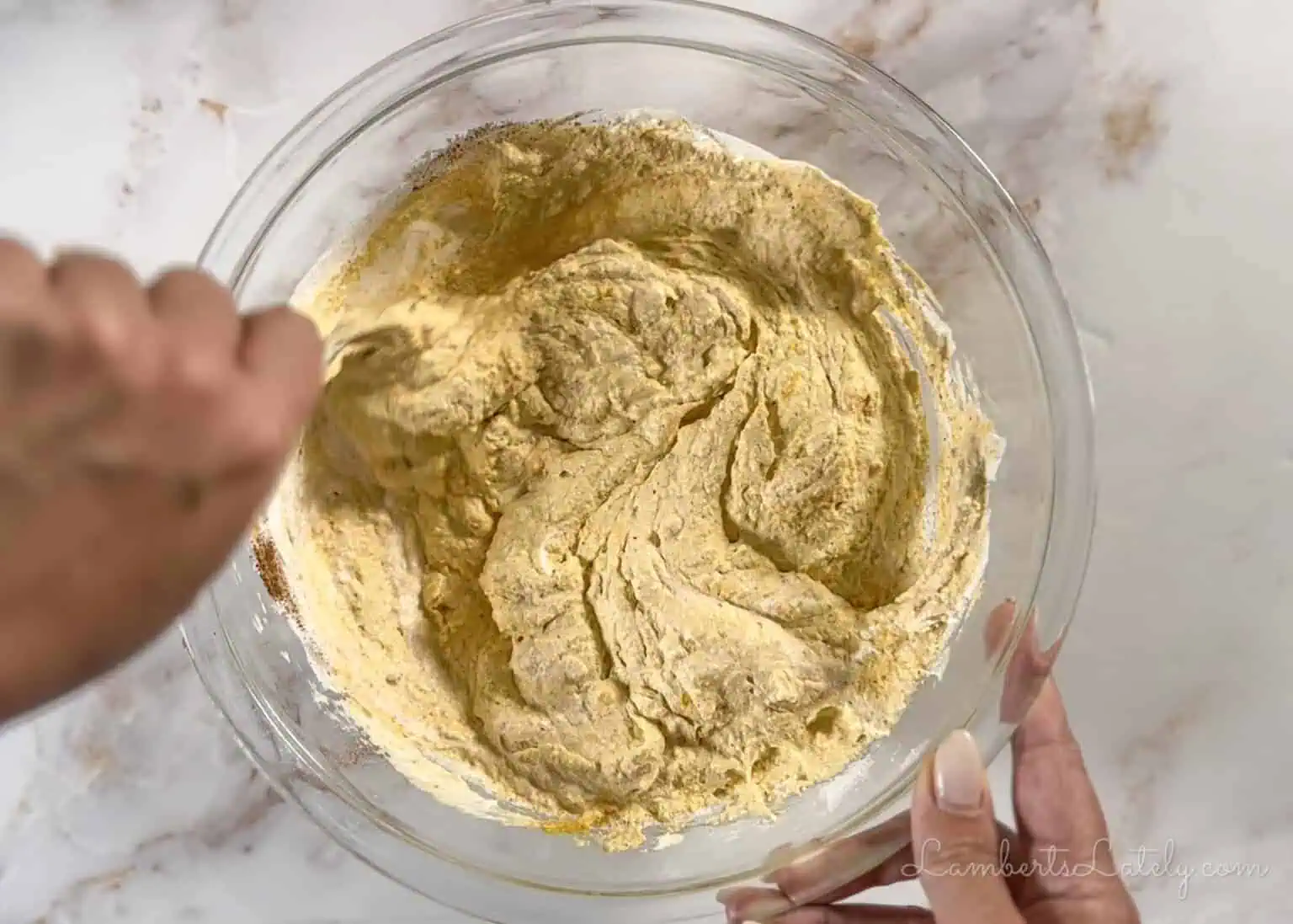 folding Cool Whip into the pumpkin mixture.
