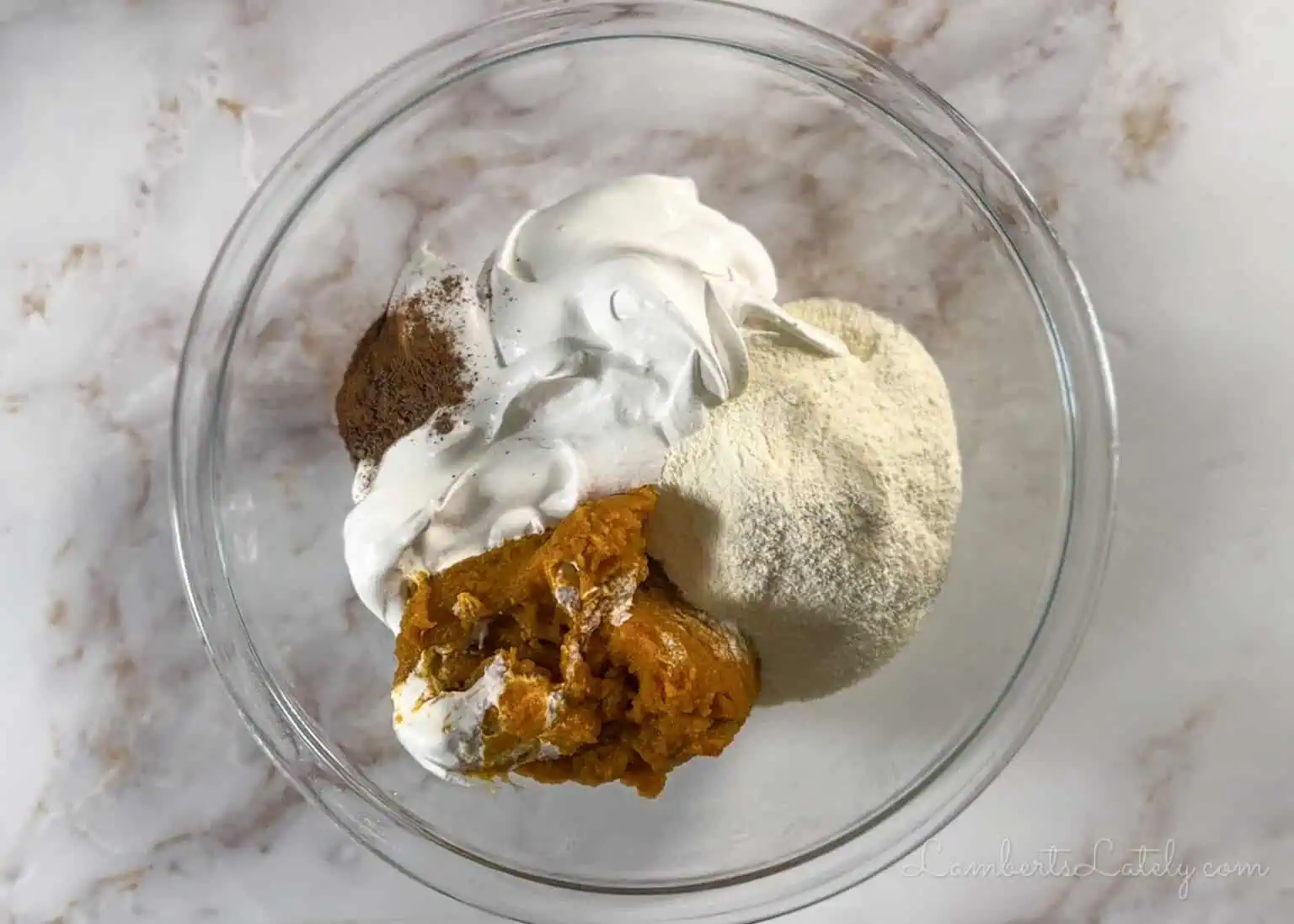 pumpkin puree, vanilla pudding mix, and pumpkin pie spice in a mixing bowl.