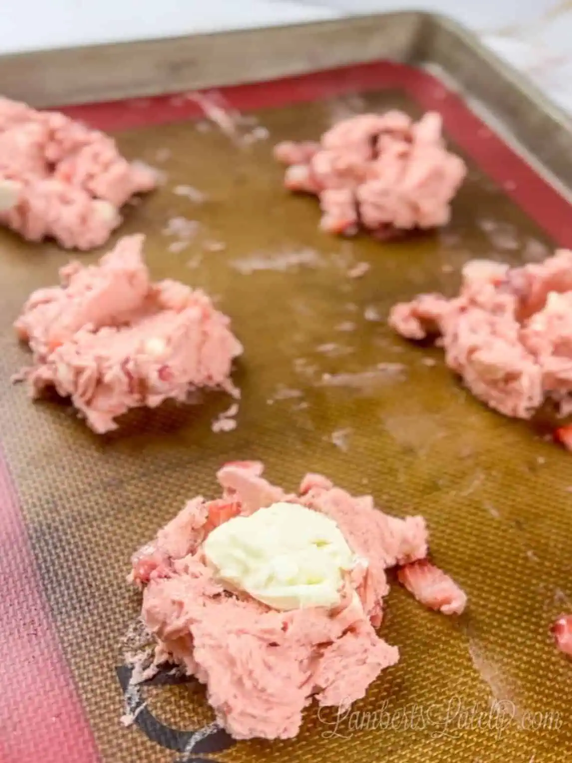 cream cheese spoons in middle of cake batter cookie dough.