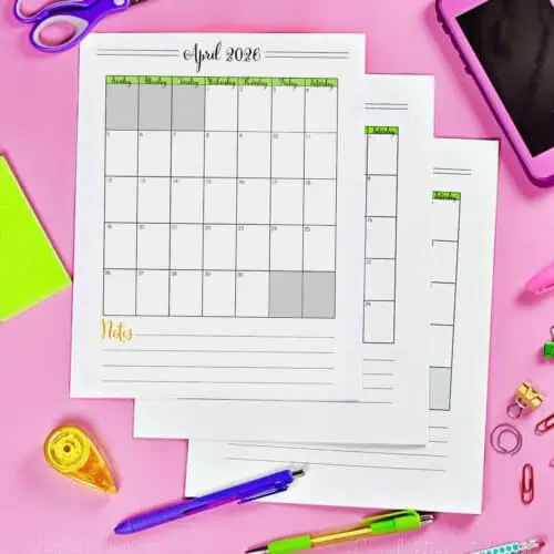 stack of calendar printables on a desk.
