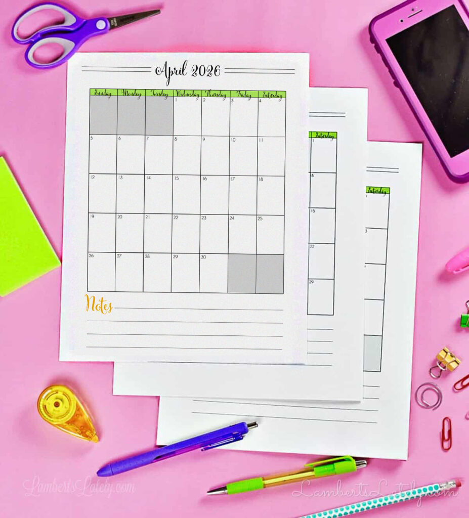 stack of calendar pdf printables on a desk.