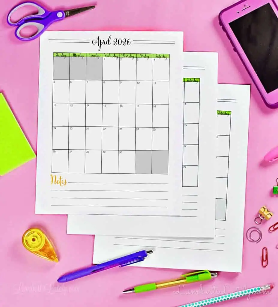 stack of calendar pdf printables on a desk.