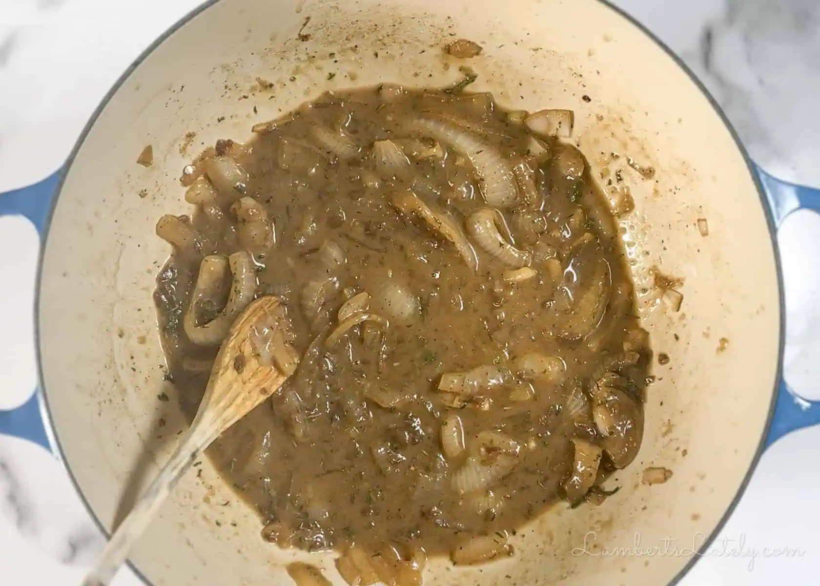 stirring french onion sauce.