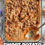 Baked sweet potato casserole with canned yams and crumb topping in glass dish.
