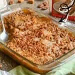 Delicious caramel apple dump cake with pecans in a glass baking dish.
