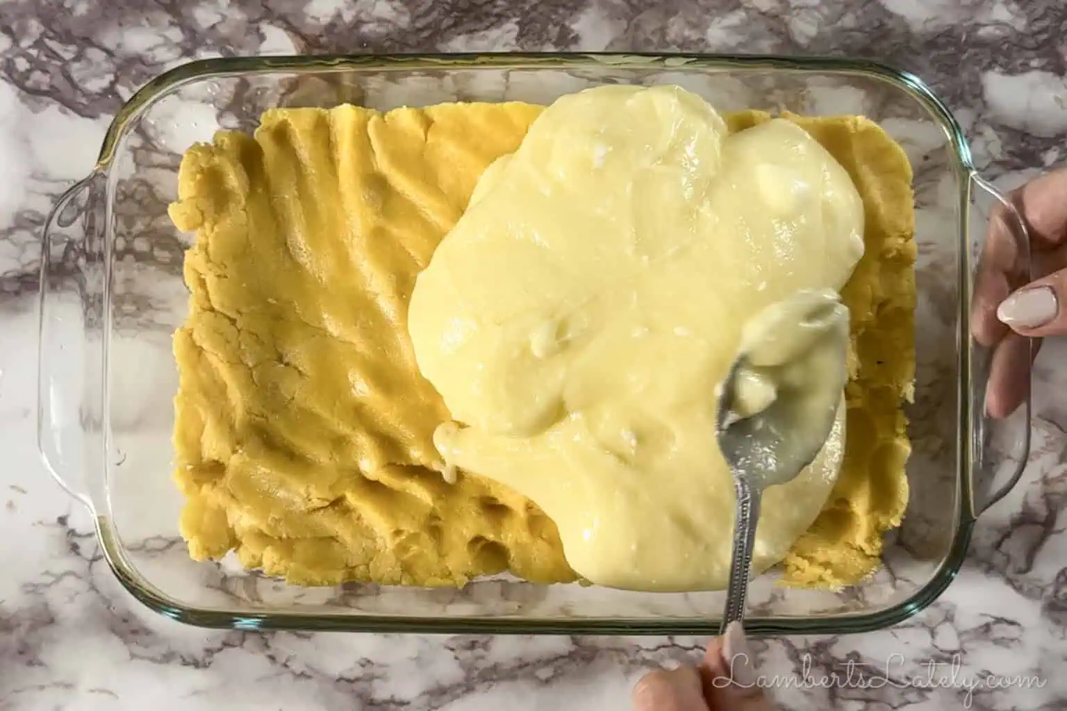 adding cream cheese layer to baking dish.