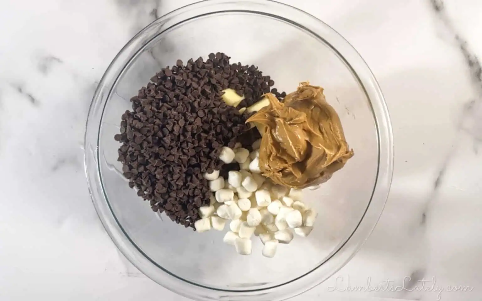 peanut butter, chocolate chips, and marshmallows in a bowl.