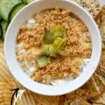 Fried pickle dip with chopped pickles and crispy crackers on side.
