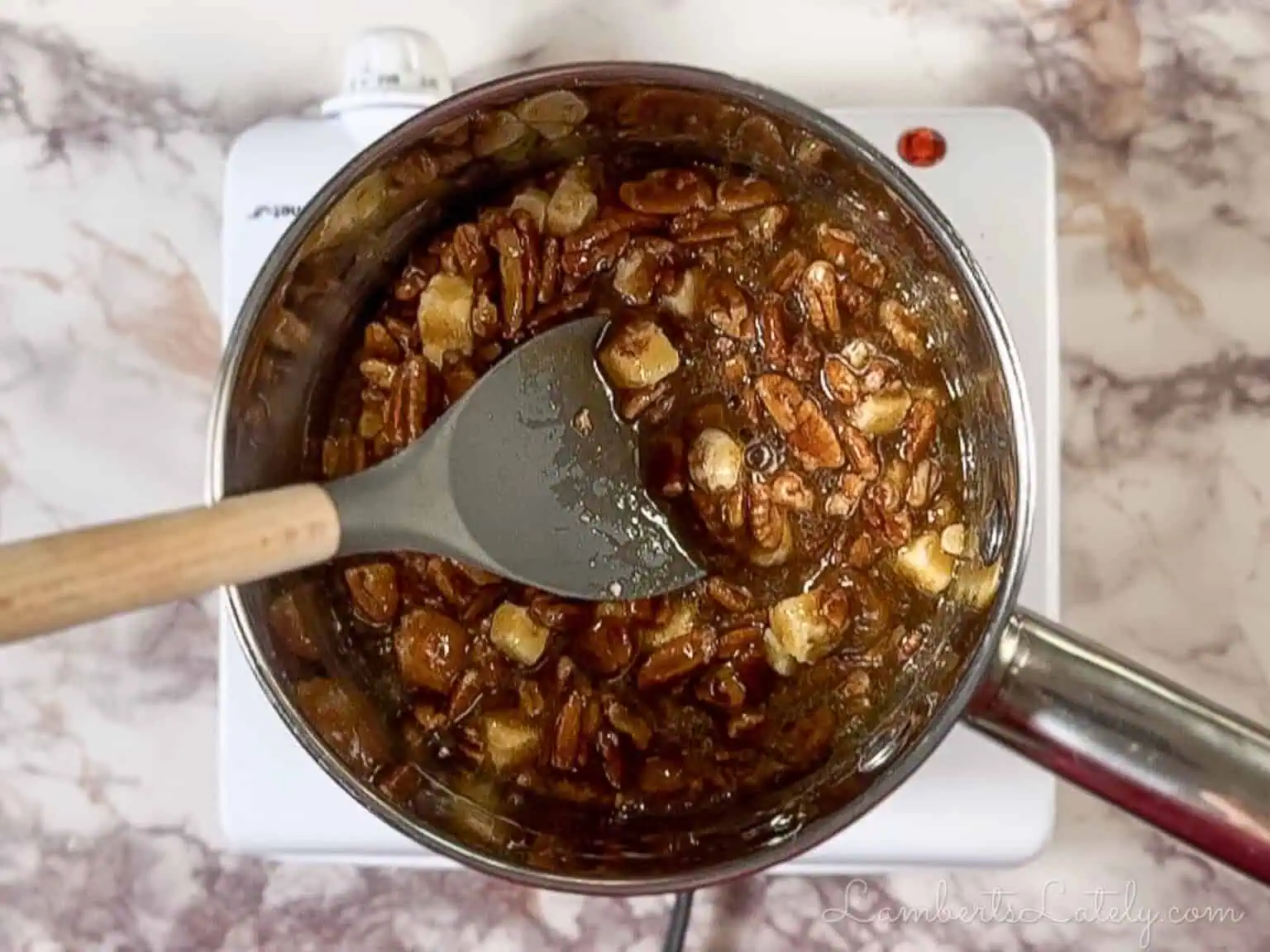 cooking pecan pie mixture in a saucepan.