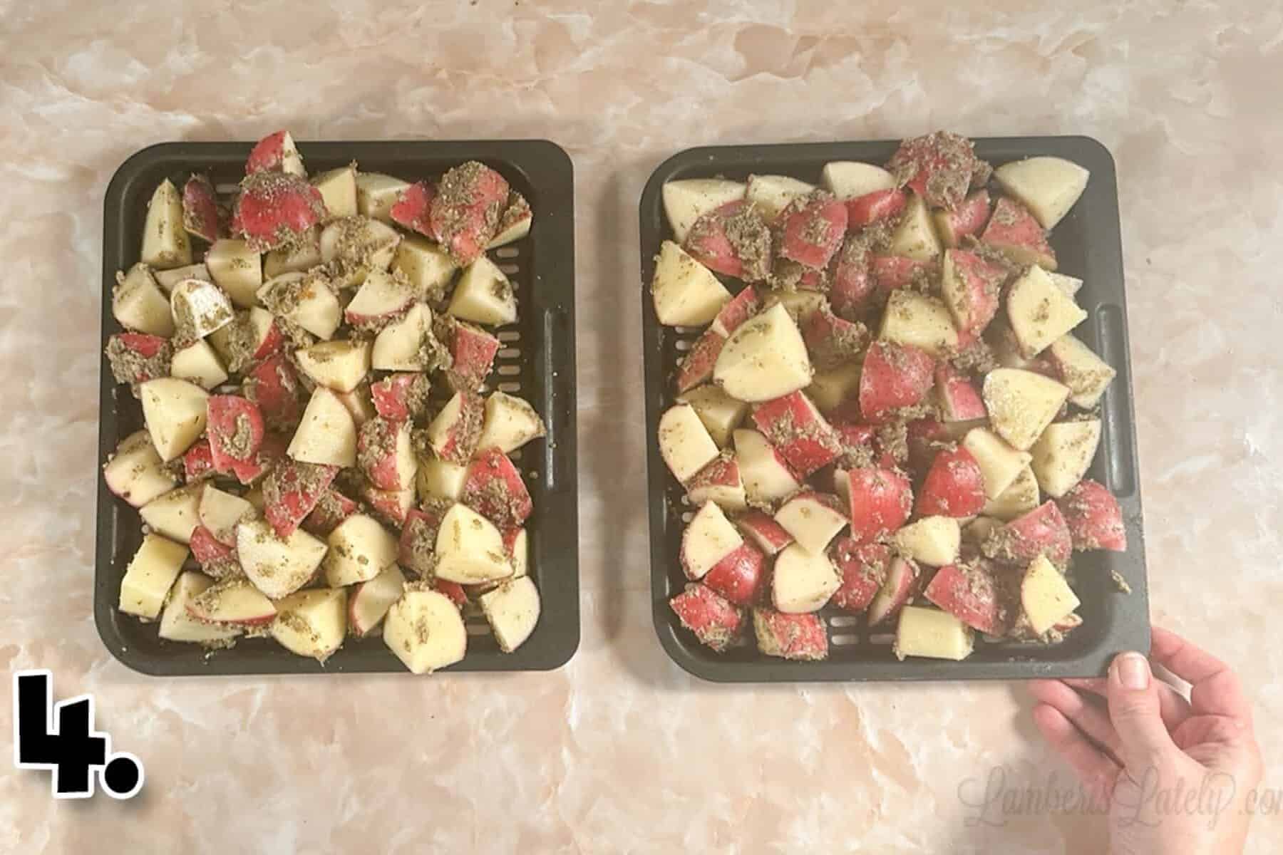 red potatoes covered in seasoning on air fryer trays.