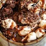 Hot cocoa mug cake with marshmallow lava center and chocolate drizzle.
