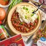 Delicious pressure cooker red beans and rice with ham and bacon, garnished with green onions.