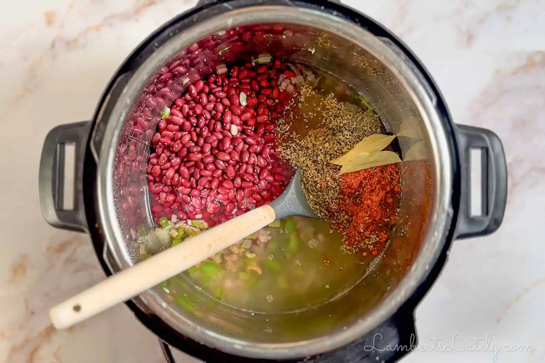 adding beans, water, and seasonings to the instant pot.