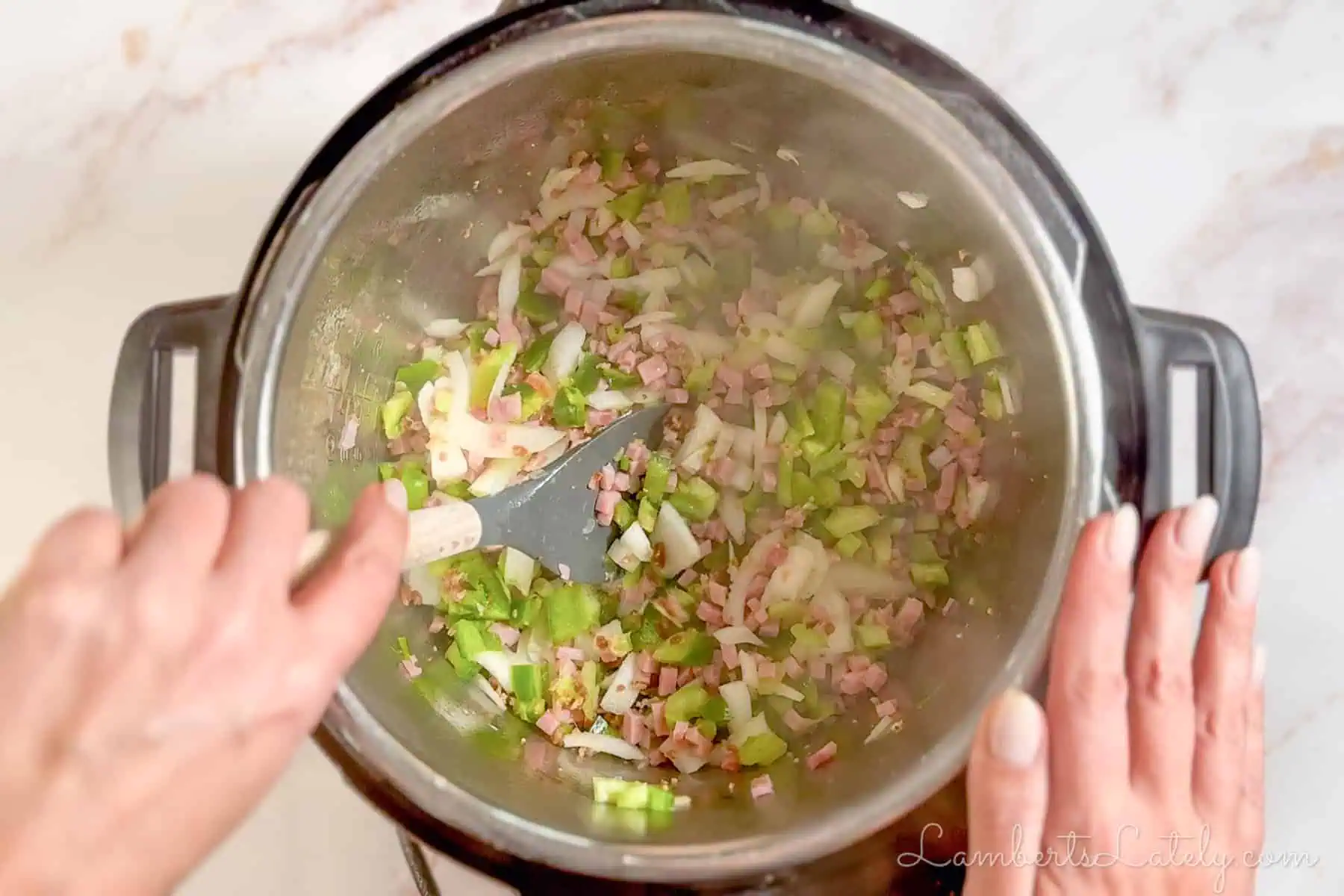 adding vegetables to the ham and bacon.