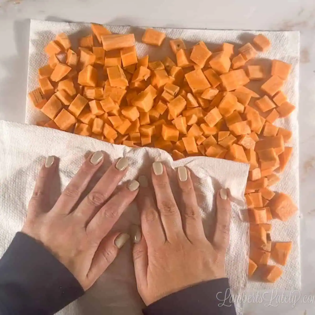 drying sweet potato cubes in paper towels.