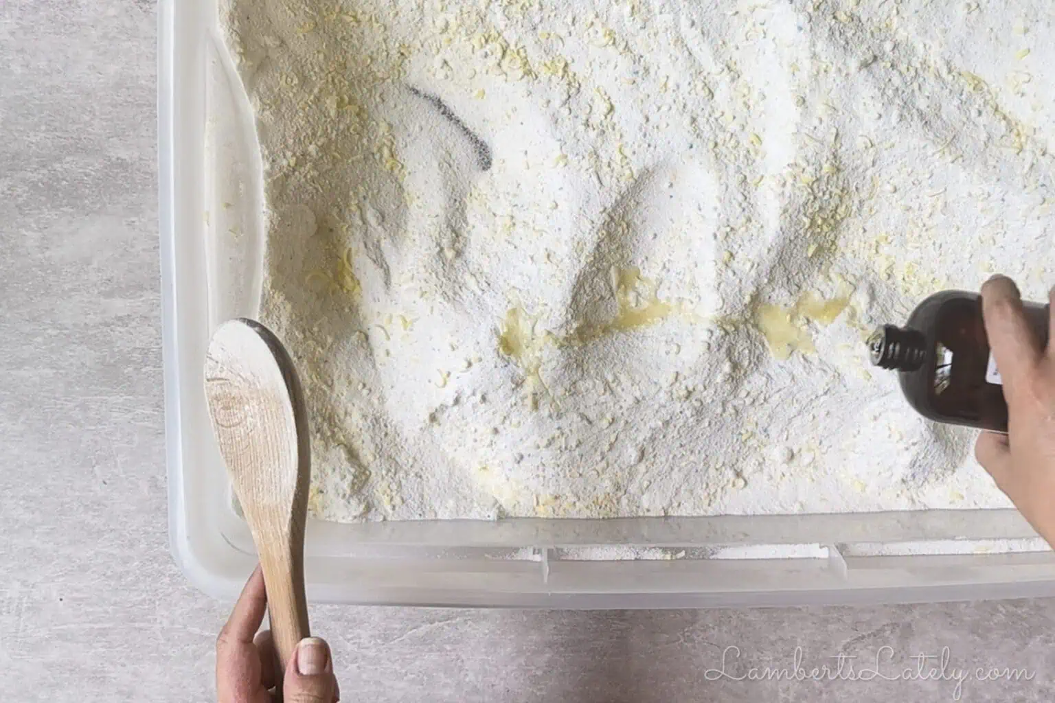 pouring fragrance oil into laundry powder.