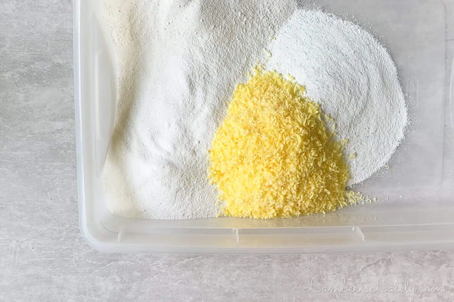 ingredients for diy laundry powder in a large container, before stirring.