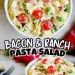 Bacon ranch pasta salad with cherry tomatoes and green peas in a white bowl.