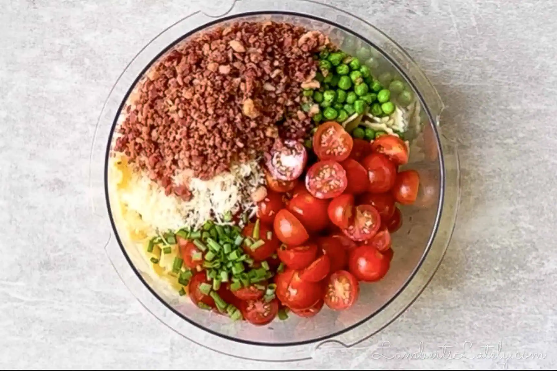 ingredients for bacon ranch pasta salad, separated, in a large bowl.