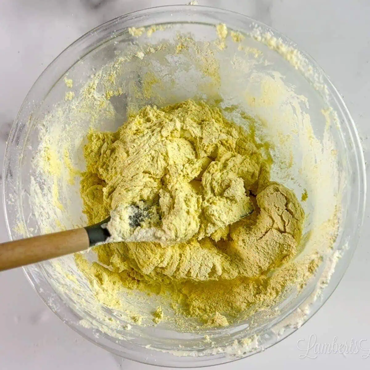 Lemon Cool Whip cookie dough in a glass mixing bowl.